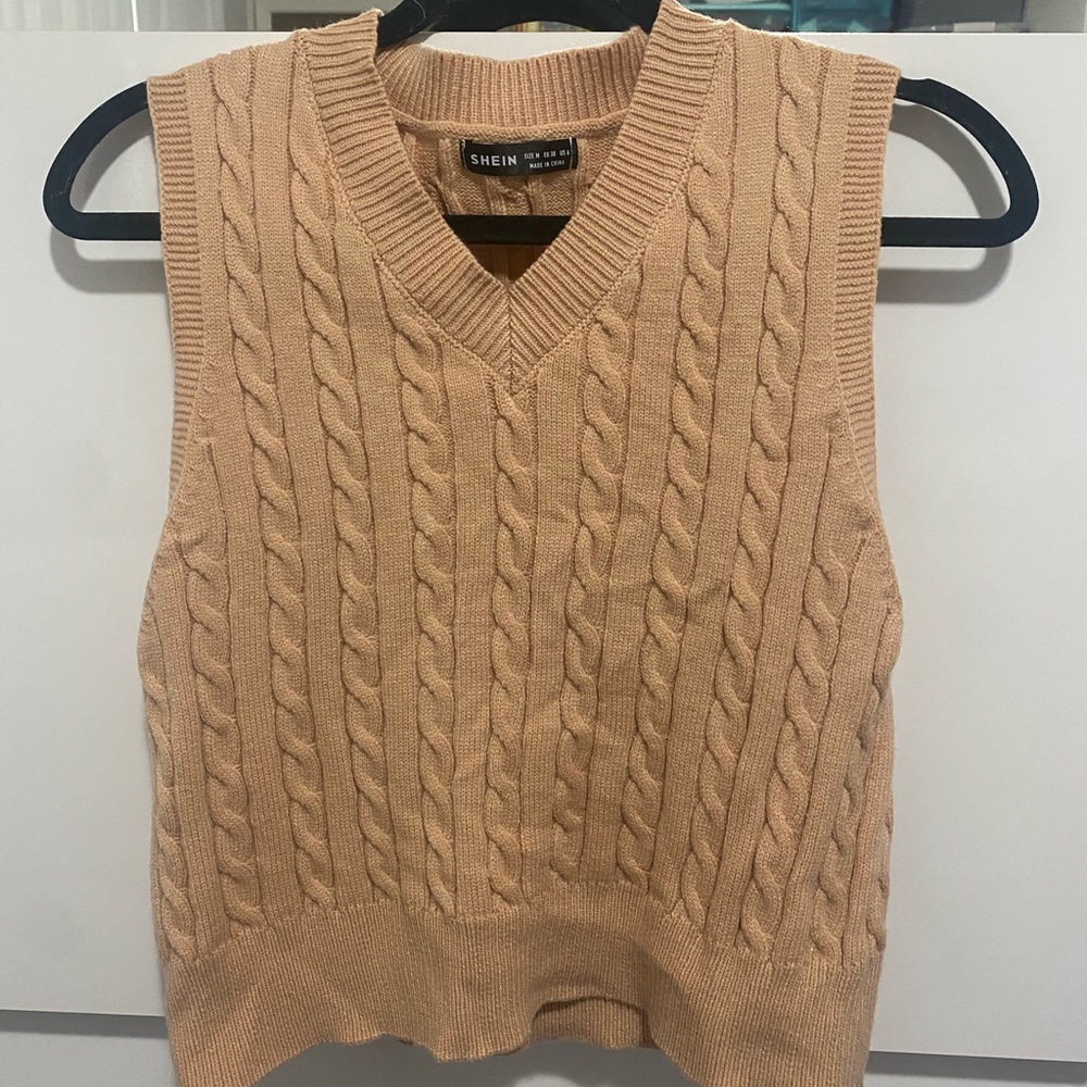 Knit sweater vest.